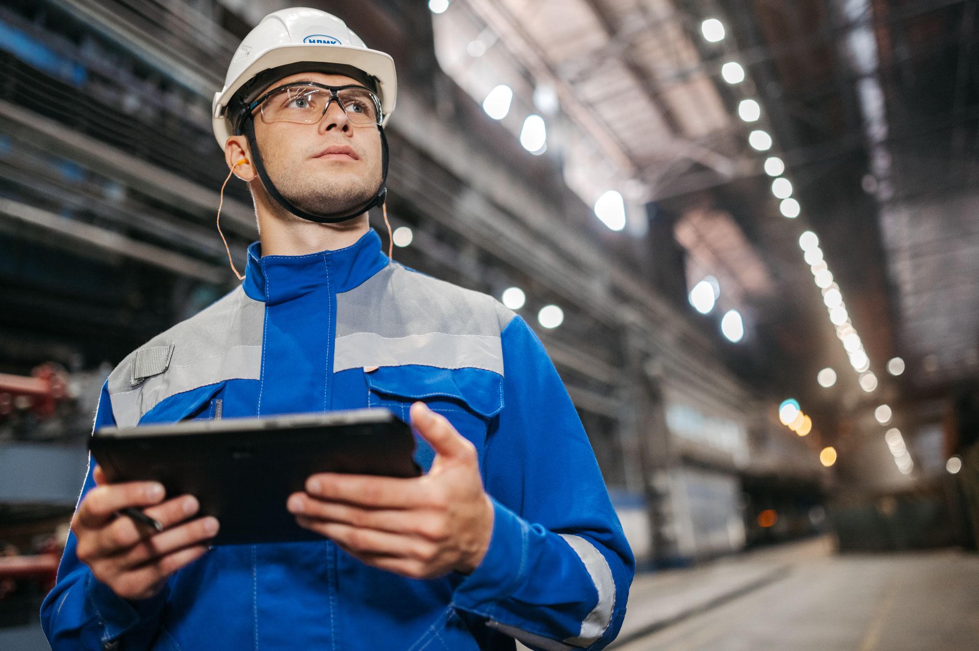 An engineer reading live plant data on a tablet